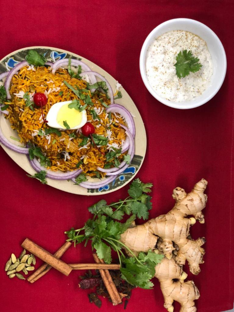 Kashmiri Vegetable Biryani · Basmati rice cooked with seasonal vegetables and Indian herbs with raita.