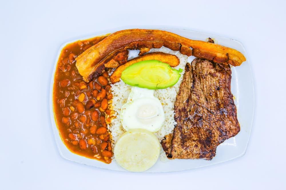 Bandeja Paisa · Steak, grilled chicken,or ground beef, pork rinds , egg, corn cake, sweet plantains, aguacate, rice and beans. *NO SUBSTITUTES*