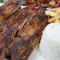 Costillas de Res · Short ribs, rice, french fries and salad.