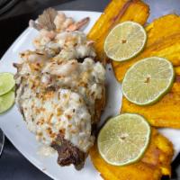 Mojarra con Camarones en salsa de coco  · Whole tilapia with shrimp in Coconut sauce served with rice and beans 