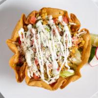 Taco Salad · Your choice of classic meat served in a deep-fried flour tortilla with beans, lettuce, pico ...