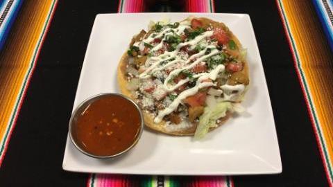 Tostada · Deep-fried corn tortilla topped with beans, lettuce, pico de gallo, Cotija cheese, sour cream and your choice of meat.