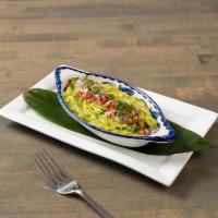 Guacamole de la Casa · Traditional dip made with mashed avocados. Topped with diced tomato, onions, and cilantro. S...