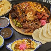 Parrillada · A hot sizzling pan with different meat cuts such as, beef fajita, zarandeado chicken breast,...