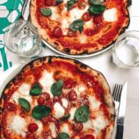 Margherita Pizza · Virgin olive oil, Roma tomatoes, fresh basil, Parmesan and mozzarella cheese. Tomato sauce a...