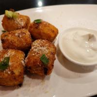 Loaded Tater Tots · Jumbo tater tots stuffed with cheddar cheese, bacon, scallion, and served with sour cream fo...