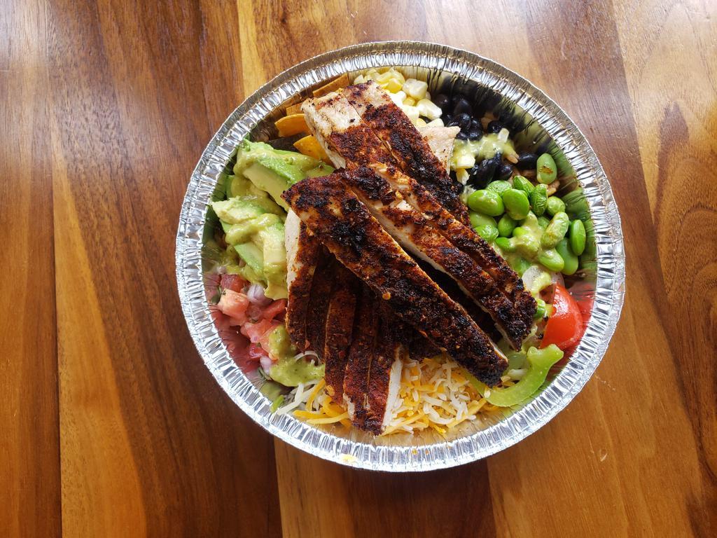 Blackened Chicken Fajita Bowl · Blackened Chicken over mixed dirty rice with kale in a cilantro lime dressing topped with tortilla strips, roasted corn, black beans, pickled fajita veggies, avocado, pico de gallo, shredded cheese, edamame, and a chipotle aioli.  Full of flavor grain and green bowl to cool you down!
