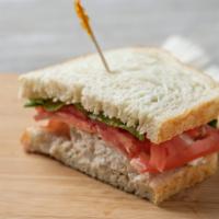 Chicken Salad Sandwich · Includes mayonnaise, spicy mustard, tomato, lettuce and red onion on sourdough.
