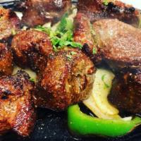 Lamb Boti Kabab · Marinated lamb tenderloins pieces barbecued in tandoor, sauteed with minced onions, tomato, ...
