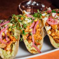 Chicken Tinga Tacos · House-smoked pulled chicken, avocado mash, pickled red onion, grilled corn, micro cilantro, ...