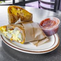 Deluxe Breakfast Burrito · 3 eggs, ham, bacon, cheddar cheese and potato.