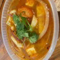 Small Tom Yum Soup · Hot and sour soup. Hot and sour lemongrass soup with mushrooms, tomatoes, onions and topped ...