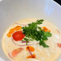 Large Tom Kha Soup · Coconut milk soup. Coconut lemongrass soup with mushrooms tomatoes, onions and topped with g...