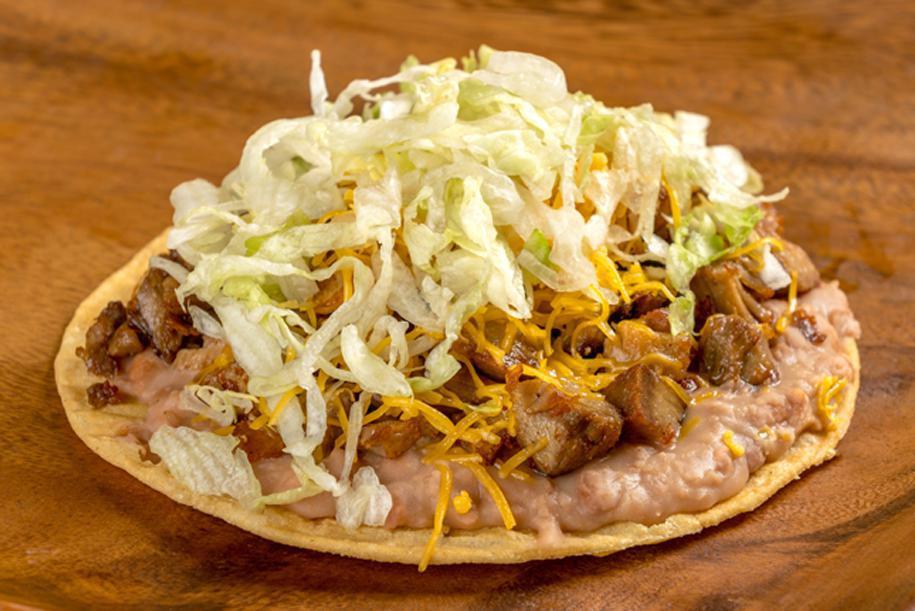 Carnitas Tostada · Refried beans, grilled pork, cheese, and lettuce.