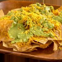 Chips with Guacamole Tostada · Corn tortilla chips, guacamole, and cheese.