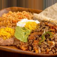 4. Fajitas · Chicken or steak mixed with onion, bell pepper, and tomato, topped with guacamole and sour c...