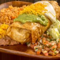 13. Chimichanga Plate · Shredded beef or chicken burrito, deep fried, and topped with guacamole, sour cream, cheese,...