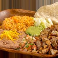 15. Carnitas Platter · Grilled pork topped with guacamole, pico de gallo, and lettuce. Comes with 1 flour tortilla.