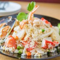 49. Seafood Fried Rice · Fried rice with combination of seafood, onions, egg, tomatoes, peas, and carrots.