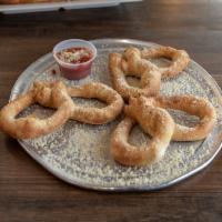 Parmesan Pretzels · Made with our classic dough, served coated in garlic butter, Parmesan, and a side of mellow ...