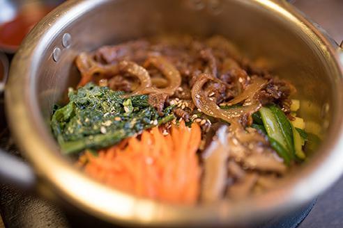 Bulgogi Bulbap · Traditional Korean bulgogi (beef) with sauteed shiitake mushroom, spinach, zucchini, carrot served over white rice.  Comes with gochujang sauce and kimchi.