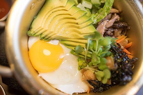 Sunny Avo · Fresh avocado, fried egg, seasoned dried seaweed, lightly fried tofu and mixed greens served over white rice.  Comes with Wasabi-Soy sauce and kimchi. Vegetarian and gluten free.