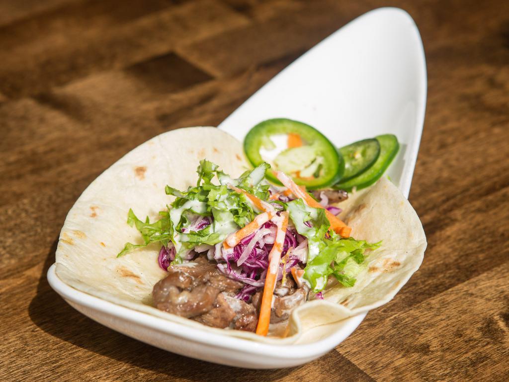 Galbi Taco · Premium short rib beef marinated in traditional galbi sauce with fresh ginger cabbage slow. Single serve.