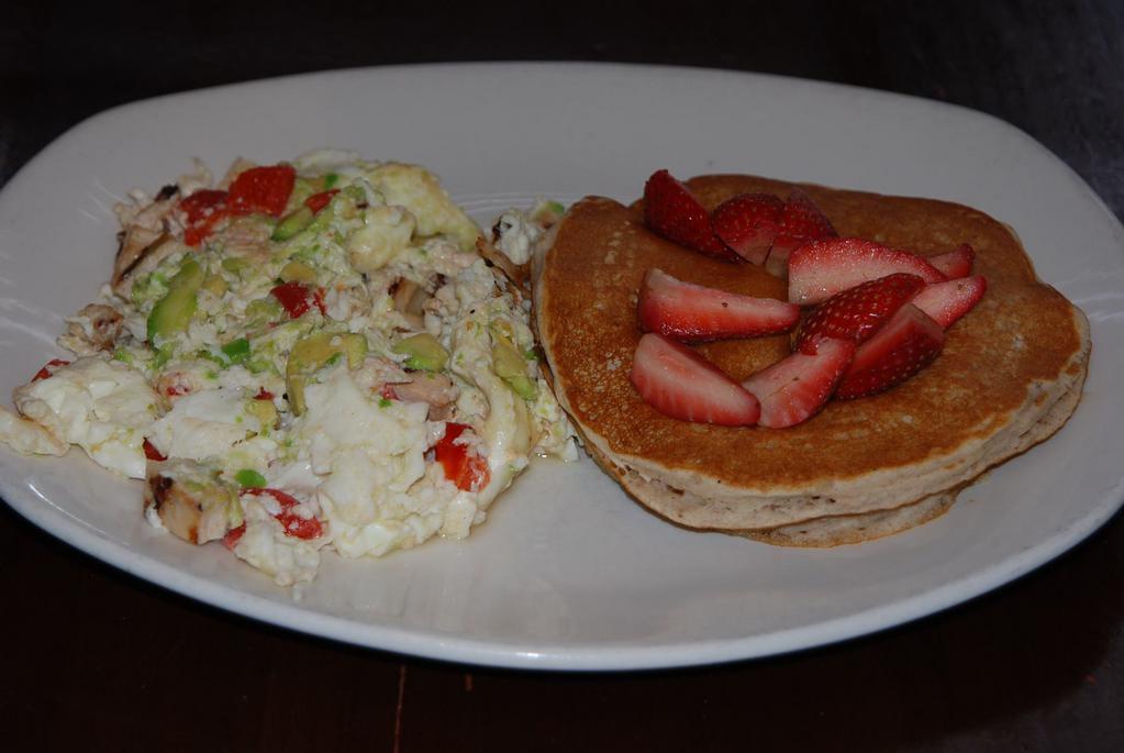 Sandra Scrambler  · Egg whites scrambled with chicken, roasted red peppers and avocado, includes multi-grain pancakes with fresh strawberries. 