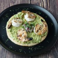 Crunchy Arepa Con Camarones · Fried or roasted corn cake with guacamole and shrimps.