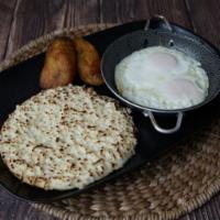Arepa Con Queso Y Huevos En Cacerola · Sunny Side Up Eggs and  Arepa with melted Cheese