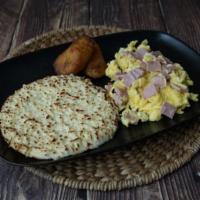 Arepa Con Queso Y Huevos Con Jamón · Scrambled Eggs with Ham, Arepa with melted Cheese.