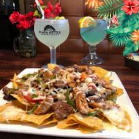 Nachos Supreme · Ground beef or shredded chicken topped with lettuce, pico de gallo and sour cream. 
