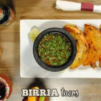Birria Tacos · Three corn tortillas dipped in birria style beef broth cooked to perfection on the grill, st...