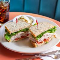 Cold Turkey Sandwich · Roasted turkey breast, mayo, lettuce, tomatoes on double baked rye. Served with your choice ...