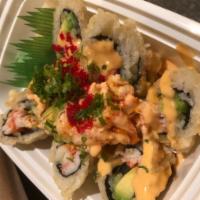 Volcano Roll · Shrimp, avocado and kani roll topped with seared crawfish salad with chef's special sauce.