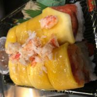 Junko's Roll · Spicy tuna, blue crab, lobster, eel and avocado. Topped with mango and kingcrab. Served with...
