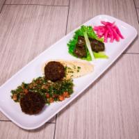 Vegetarian Plate · Two grape leaves, tabouli, hummus and two falafel. Served with pickles, tomatoes, lettuce an...
