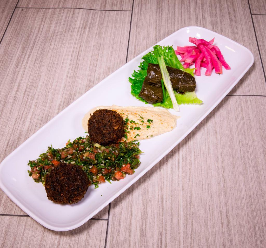 Vegetarian Plate · Two grape leaves, tabouli, hummus and two falafel. Served with pickles, tomatoes, lettuce and parsley.
