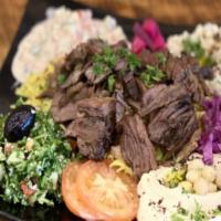 Beef Shawarma Plate · slices of seasoned beef served with rice, hummus, baba ghanoush, tabbouleh salad, tahini sal...