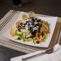 Greek Salad · A​ mixture of romaine lettuce, tomatoes, cucumbers, green pepper, and sliced red onion. Topp...