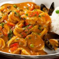 Pescado con Mariscos · A seafood combination of grilled fish filet, mussels, calamari, octopus, and shrimp in a tas...