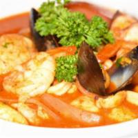 Parihuela Mixta · A delicious tomato based soup with fish, calamari, shrimp, and octopus with onions and tomat...