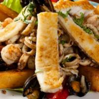 Grilled Seafood Platter / Parrillada de Mariscos · Grilled fish, calamari, shrimp, octopus, mussels. It's alot. It's delicious!