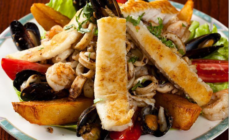 Grilled Seafood Platter · Parillada de mariscos grilled fish, calamari, shrimp, octopus, mussels. It's alot. It's delicious!