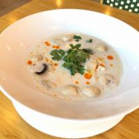 S23. Chicken Tom Kha Soup · Coconut soup with chicken, lemongrass, onion, cilantro, tomato, and mushroom.