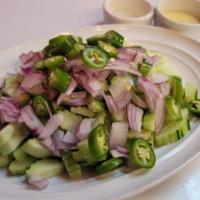 I26. Cucumber Salad · Fresh cucumber slices, carrot, red onion served with sweet vinaigrette.