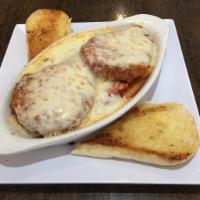 Chicken Parmigiana · Herb crusted tender breast of chicken with melted mozzarella.  Served over a bed of mostacci...