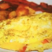 Omelette au Bacon · 2 eggs, bacon, sauteed potatoes, tomatoes, roasted peppers and cheddar cheese.