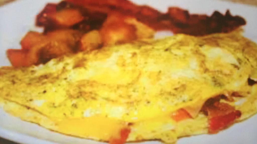 Omelette au Bacon · 2 eggs, bacon, sauteed potatoes, tomatoes, roasted peppers and cheddar cheese.