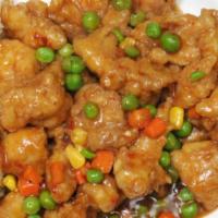 General Tso's Chicken · Served with salad and rice.